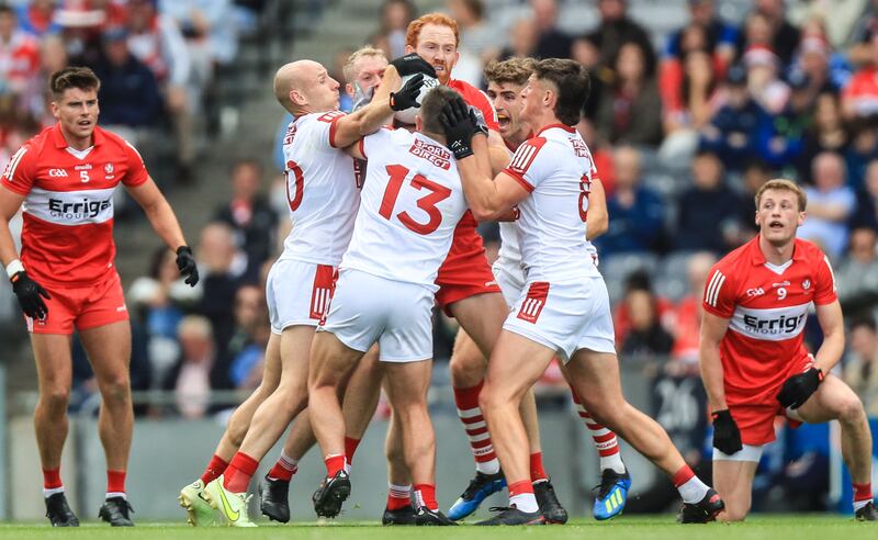 Derry's Conor Glass is surrounded by Cork players. Photograph: Evan Treacy/Inpho