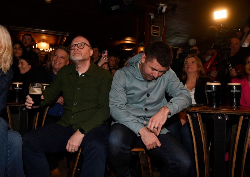 Kneecap writer-director Rich Peppiatt (right) and producer Trevor Birney watching a screening of the Oscar nominations at Madden's Bar in Belfast. The film missed out on a nomination. Photograph: Mark Marlow/PA Wire