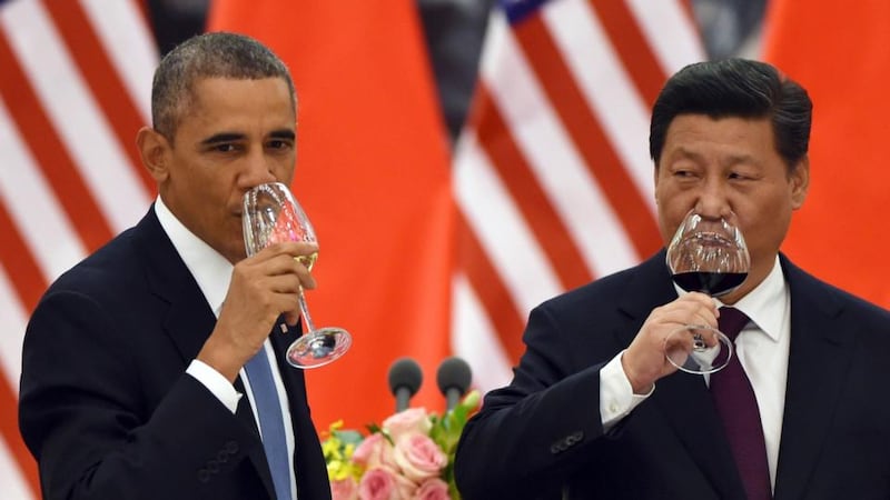 President Barack Obama and China’s President Xi Jinping drink a toast at a lunch banquet in the Great Hall of the People in Beijing, on November 12th, 2014.  Photograph: Greg Baker/Pool via The New York Times