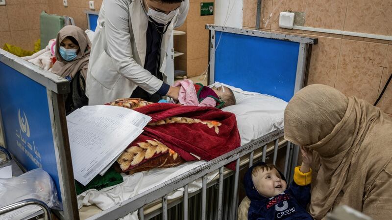 A doctor examines seven-month-old Amena in the malnutrition ward of the Indira Gandhi Children’s Hospital in Kabul. Photograph: Jim Huylebroek/New York Times