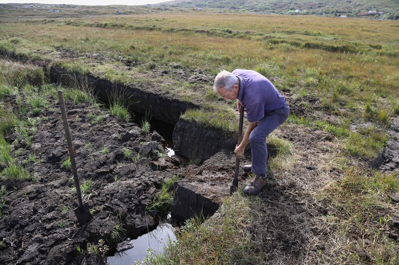 Matt Corbett using a sleán to cut turf on the bog at Cuilleen, Carna. Photograph: Joe O'Shaughnessy