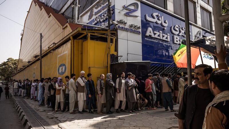 People line up outside a bank in Kabul on Sunday. Photograph: Jim Huylebroek/New York Times