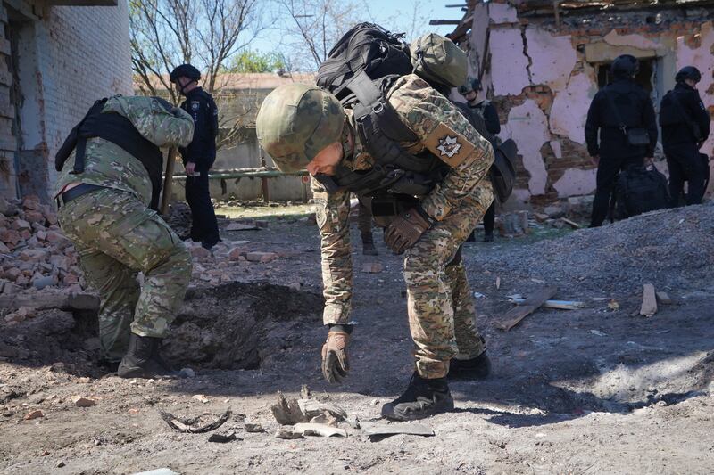 A Ukrainian officer examines fragments of a guided bomb after a Russian air raid in Kharkiv. Photograph: Andrii Marienko/AP