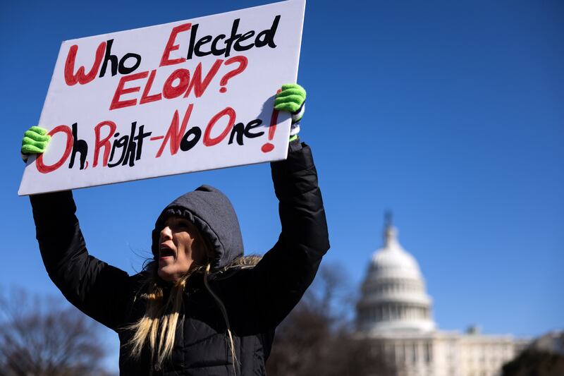 A protester holds a sign during a rally last Monday in Washington DC to denounce the Trump administration. Photograph: Tierney L Cross/The New York Times
                      