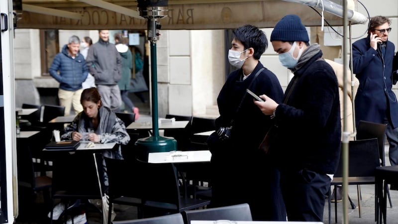 Two tourists wear a protective mask in Milan on Wednesday. Photograph: Ourad Balti Touati/EPA