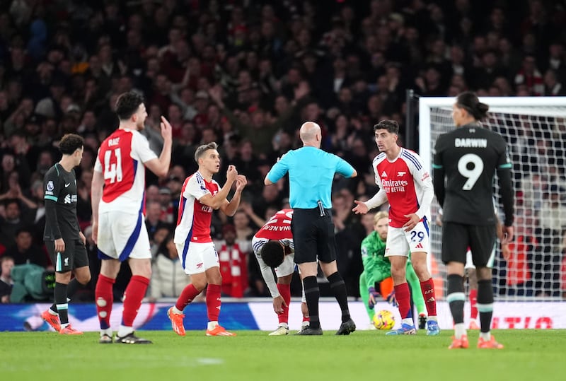 Arsenal players question referee Anthony Taylor after a goal is disallowed. Photograph: Adam Davy/PA