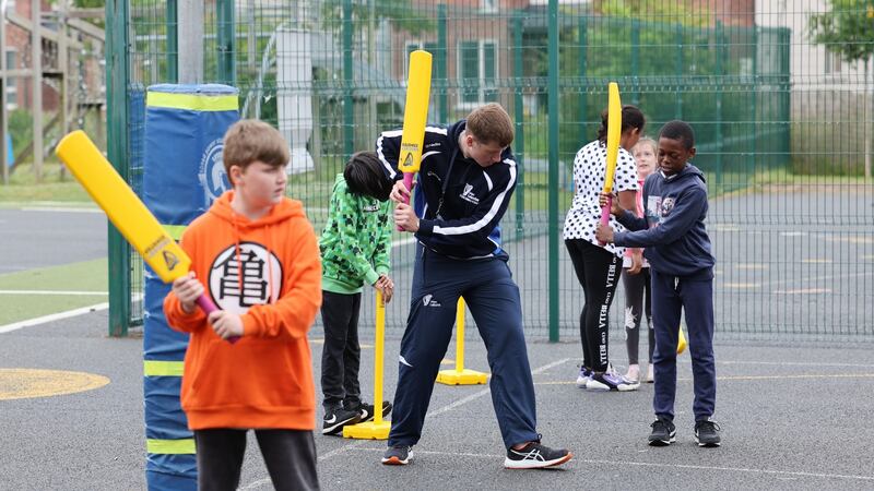 Cricket Coach Mitchell Thompson teaching cricket to children  at Tyrrelstown Educate Together in Dublin. Photograph: Alan Betson/The Irish Times