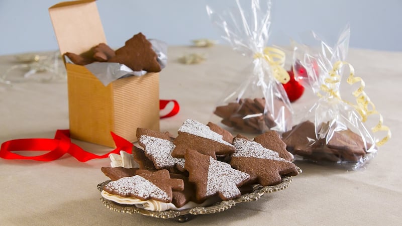 Roll out the cookie dough on a floured counter, and cut into Christmassy shapes. Photograph: Brownes photography