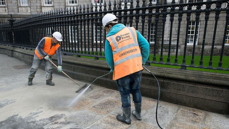 The pavement outside Trinity College  Dublin was removed, cleaned and  re-laid. Photograph: Dave Meehan