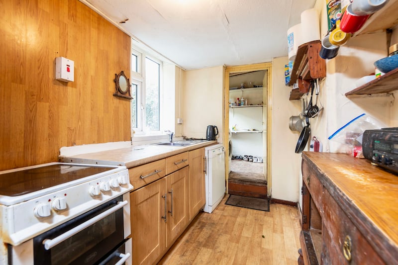 The kitchen is small but there is scope to open up the ceiling to the loft space above