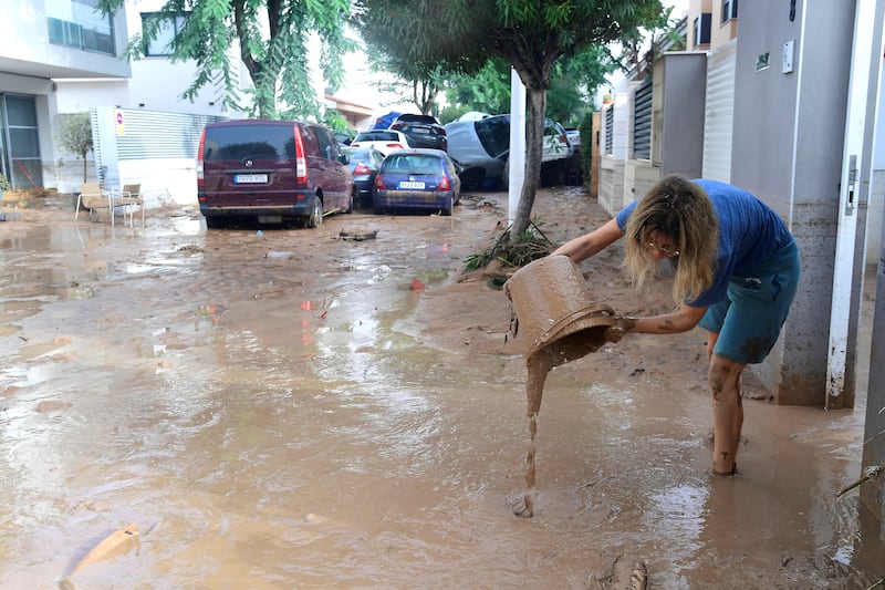 A resident cleans up  in a flooded area in Picuana, near Valencia, eastern Spain. Floods triggered by torrential rains in Spain's eastern Valencia region has left at least 51 people dead. Photograph: Jose Jordan, AFP via Getty Images