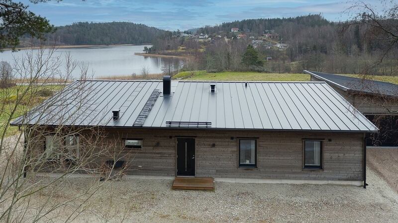 This is a modern, chalet-type, four-bedroom home with superb lake views in Vastra Gotaland, Sweden.