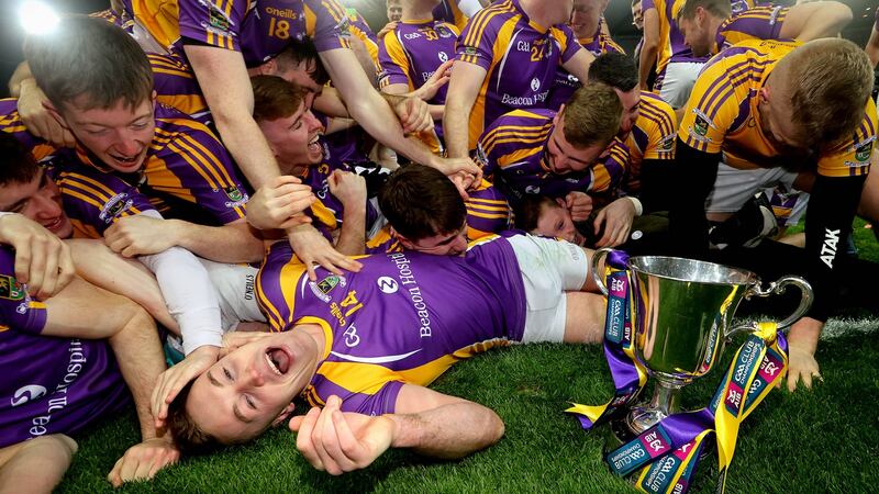 Kilmacud’s Shane Cunningham celebrates with the trophy after the Leinster final victory over Naas. Photograph: Ryan Byrne/Inpho