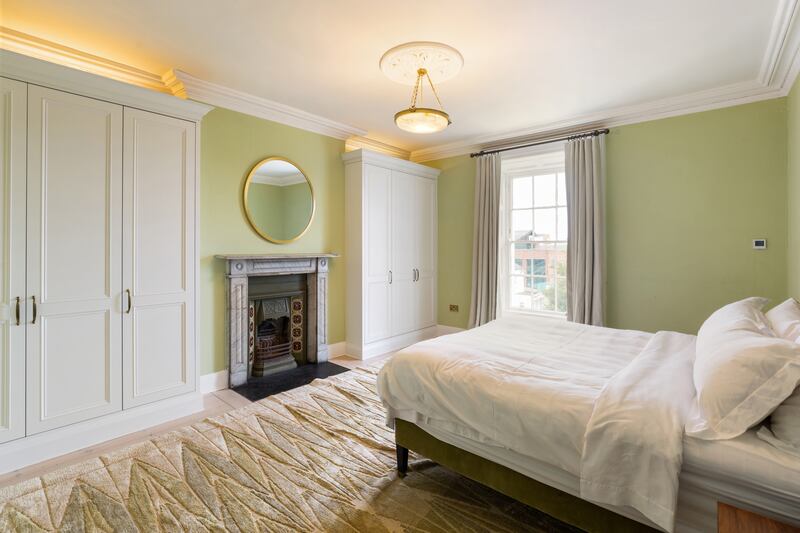 There are two large double bedrooms, each with a tiled-inset fireplace, sash windows and built-in wardrobes.