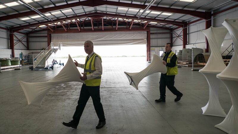 Ron Mellerick, fire security officer, and Sean Murtagh, security officer at Ireland West Airport Knock, moving tables in preparation for the visit of Pope Francis. Photograph: Keith Heneghan