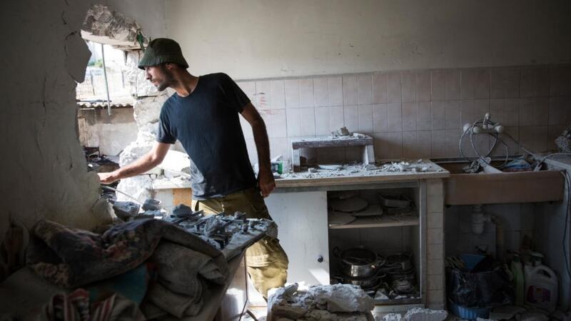 An Israeli soldier inspects an Israeli home allegedly hit by a Hamas rocket in Sderot, Israel. Photograph: Andrew Burton/Getty Images