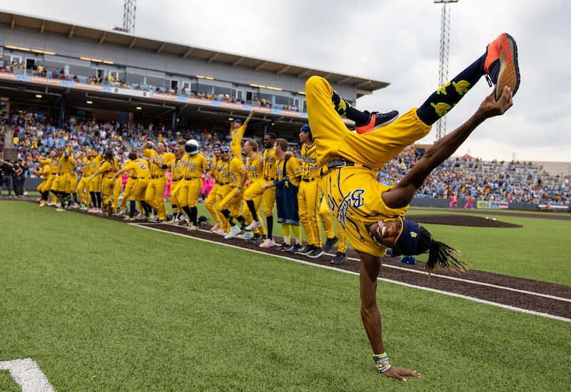 First base coach/dance instructor Maceo Harrison of the Savannah Bananas performs a dance routine in their game against the Party Animals at Richmond County Bank Ball Park in New York City.  Photograph:  by Al Bello/Getty Images