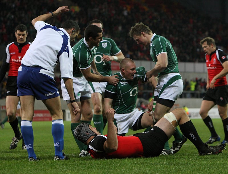 Keith Earls is congratulated by Rob Kearney and Brian O'Driscoll after scoring a try after just two minutes on his debut against Canada at Thomond park in November 2008. Photograph: Billy Stickland/Inpho