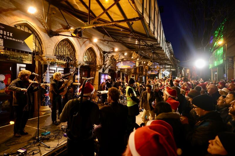 Crowds watching the annual Simon Community Christmas Eve Busk outside the Gaiety Theatre. Photograph: Alan Betson