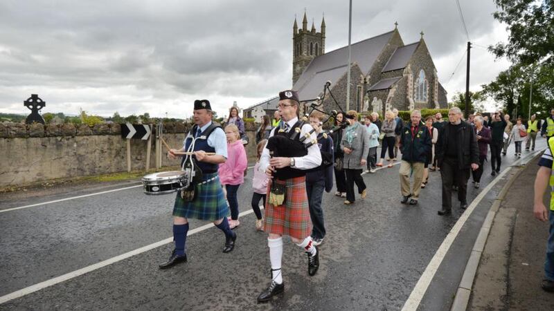 A procession moves from the graveside of Seamus Heaney at St Mary’s church in Bellaghy, Co Derry,  through the village to the Turfman sculpture for musical tributes to celebrate the life of the Nobel laureate on the first anniversary of his death. Photograph: Alan Betson