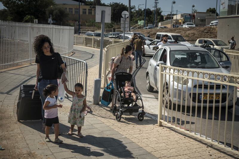 Families leave Sderot, an Israeli town near the Gaza border, on Sunday after its was evacuation was ordered by authorities. Photograph: Sergey Ponomarev/New York Times
                      