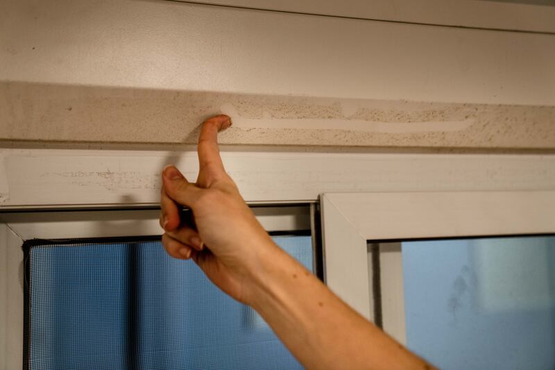 Gihana Fava running her finger through a layer of dust in her rented room at Fan Village at the World Cup in Doha, Qatar. Photograph: Erin Schaff/The New York Times