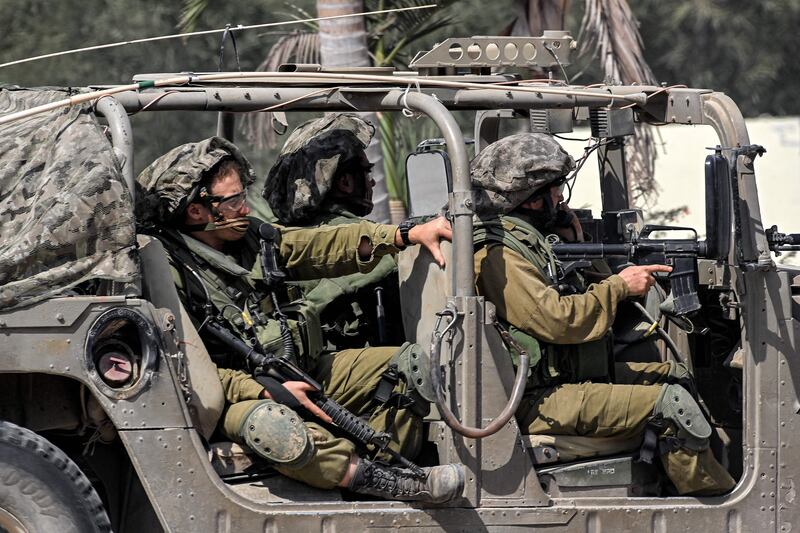 Israeli army soldiers sit in a humvee at a checkpoint near the border with the Gaza Strip in Israel's southern city of Sderot. Photograph: yuri Cortez/AFP via Getty Images