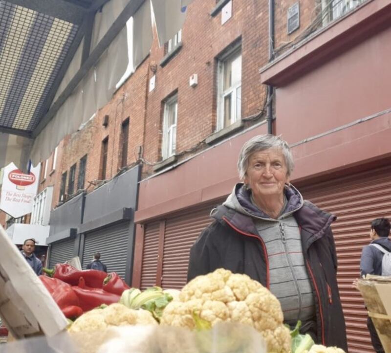 Angela Wright, whose vegetable stall is directly under the national monument (plaque pictured top right of picture). Photograph: Ronan McGreevy