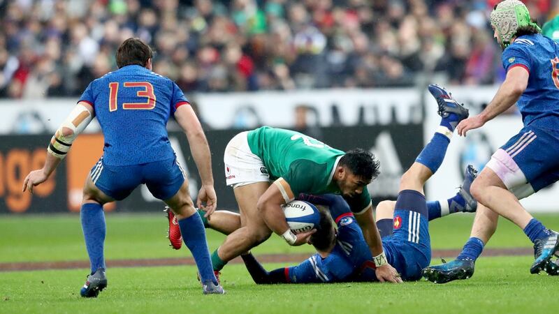 Bundee Aki runs over France outhalf Matthieu Jalibert. Photograph:  James Crombie/Inpho