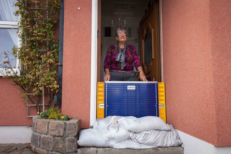 Nancy Long standing at the door of her house in the Claddagh Quay in Galway with sandbags and a plastic flood gate for protection against possible flooding from storm Callum Photo Andy Newman