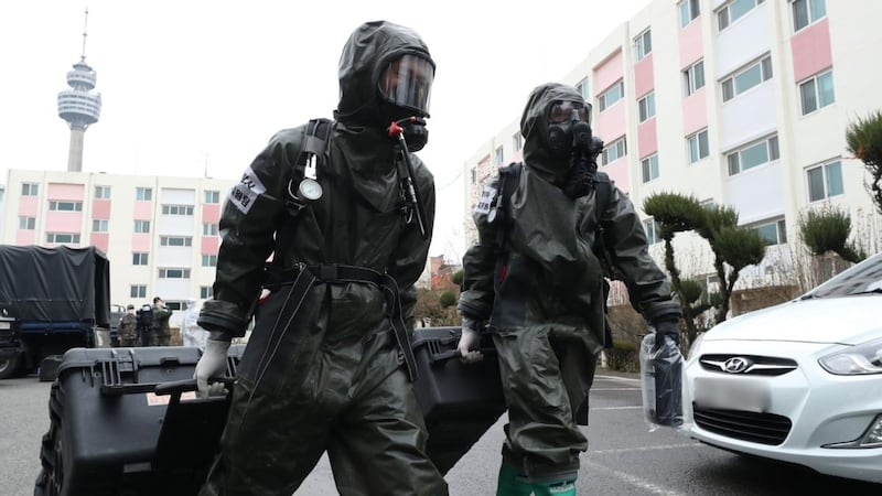 South Korean soldiers from the Armed Force CBR Defense Command wearing protective gear enter a building for disinfection work at a closed apartment complex after 46 residents were confirmed to have the COVID-19 coronavirus, in Daegu, South Korea. Photograph: Yonhap / AFP / South Korea OUT  via Getty Images