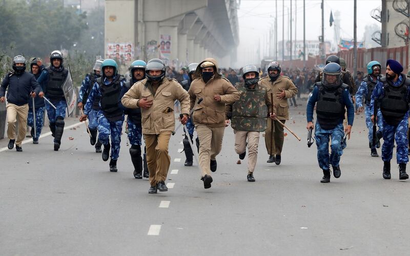 Policemen are chased by demonstrators during a protest against a new citizenship law in Seelampur,  Delhi on Tuesday. Photograph: Adnan Abidi/Reuters