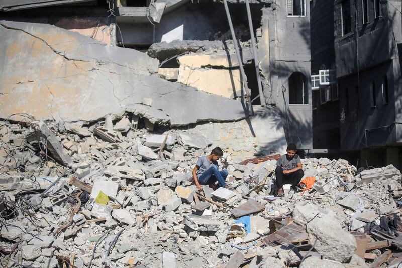 Young locals amid the rubble of buildings in Khan Yunis, Gaza Strip, destroyed during Israeli air raids, on Friday. Photograph: Ahmad Hasaballah/Getty