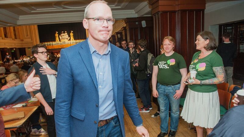 Tánaiste Simon Coveney  with Together for Yes activists at the referendum count for Cork city on Saturday. Photograph: Daragh Mc Sweeney/Provision