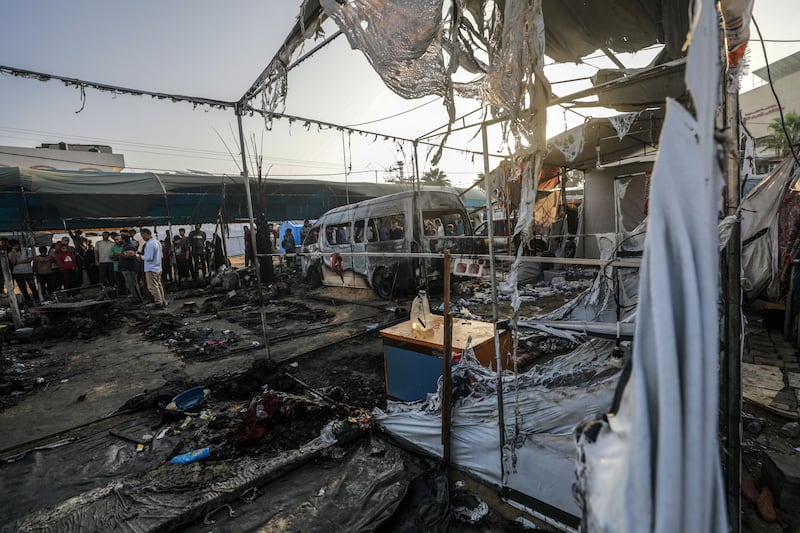 Palestinians survey the damage at a camp for internally displaced people on the premises of al-Aqsa Hospital, after the area was hit by an Israeli air strike, in Deir al Balah, central Gaza Strip on Monday. Photograph: Mohammed Saber/EPA