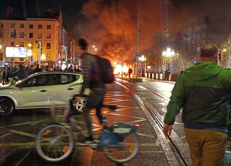 A bus burns just off O'Connell Street Bridge in Dublin during rioting on November 23rd, 2023. Photograph: Sam Boal/RollingNews.ie