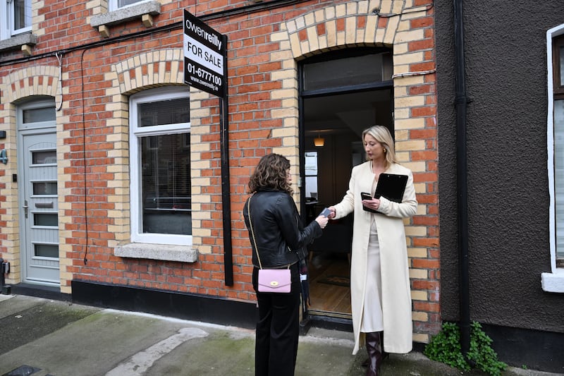 First-time buyer Aoife Gorman speaks to estate agent Isabelle O'Neill outside property for sale in Ringsend. Photograph: Bryan Meade