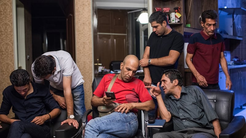 Members talk after an Alcoholics Anonymous association meeting in Tehran on August 27th. Photograph: Arash Khamooshi/The New York Times