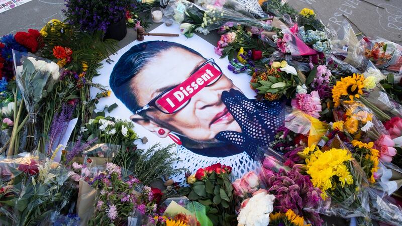 Flowers, candles and messages encircle an image of the late US justice Ruth Bader Ginsburg. It is understood her dying wish was that her successor  be appointed after the election. Photograph: Michael Reynolds