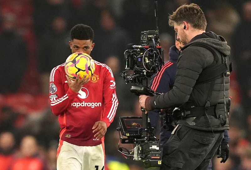 Manchester United's Amad Diallo kisses the match ball after scoring a hat-trick. Photograph: Martin Rickett/PA