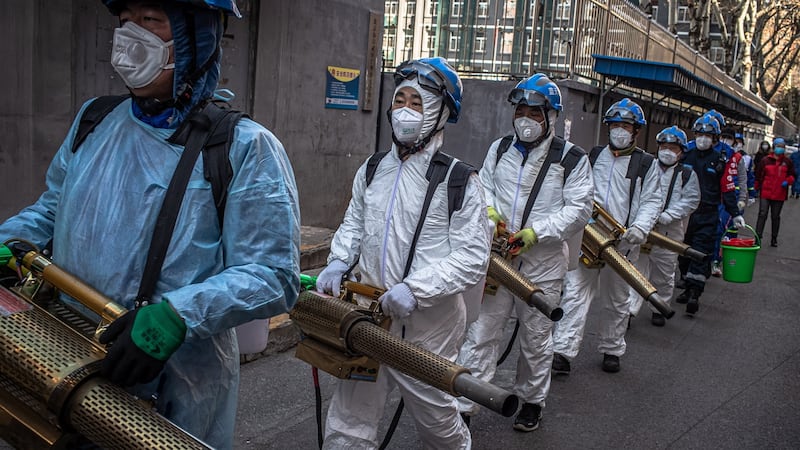 Members of the Blue Sky Rescue team disinfect a residential area as a precaution against the spread of the coronavirus in Beijing. Photograph: EPA