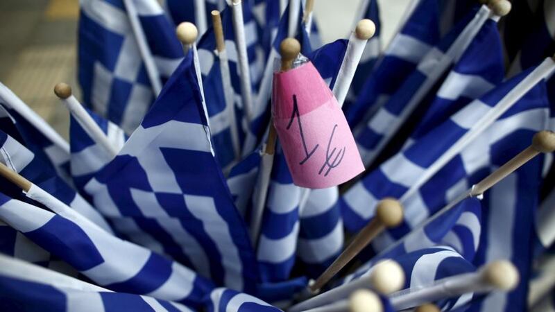 Greek national flags are displayed for sale at a one-Euro shop in Athens. Greece has said it will pay a €450 million loan installment to the International Monetary Fund due on April 9 on time. Photograph: Kostas Tsironis/Files