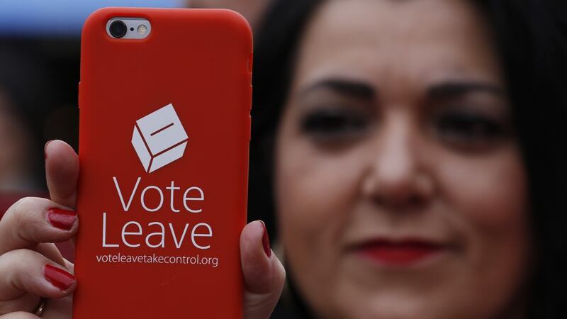 A pro-Brexit supporter holds a Vote Leave mobile phone that will potentially cost her a lot more in roaming charges should Britain decide to leave the EU. Photograph: Luke MacGregor/Bloomberg