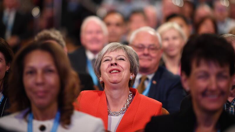 UK prime minister Theresa May laughs as she sits in the audience during the annual Conservative Party conference. Photograph: Jeff J Mitchell/Getty Images