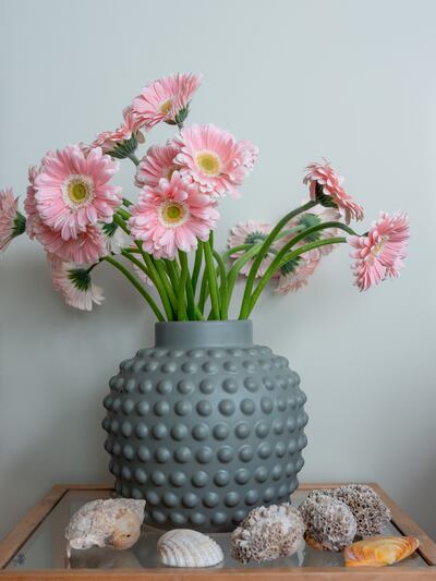 Pops of pink blend well with the Dulux Heritage Green Earth on walls