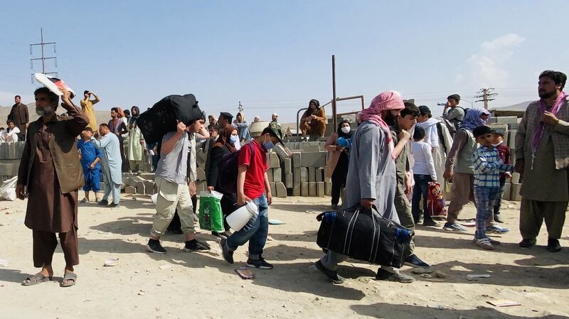 People seeking to leave Afghanistan gather outside the Hamid Karzai International Airport in Kabul on Thursday. Photograph: EPA