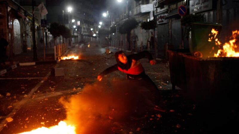 A Palestinian throws stones towards Israeli troops during clashes in the West Bank city of Ramallah this morning. Israeli troops killed a Palestinian in the occupied West Bank today, Palestinian medics said. Photograph: Mohamad Torokman/Reuters