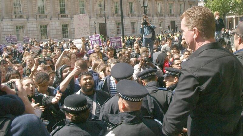 Kevin Carroll (right), co-founder and co leader of the EDL faces across a line of police UAF demonstrator outside Downing Street.  Photograph: Max Nash/PA Wire