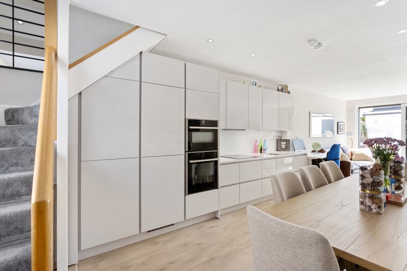 The kitchen lies inside the front door and runs into the living room. Photograph: Angela Mujica