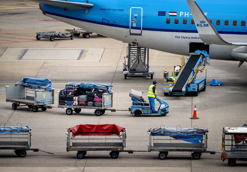 Employees prepare to load luggages on planes at Amsterdam's Schiphol Airport. At times, at many airports across Europe, there aren't staff available to unload newly arrived planes, meaning they end up flying back to where they set out from with the same luggage still onboard. Photograph: Koen Van Weel/ANP/AFP via Getty Images